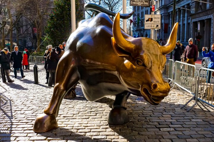 a statue of a bull on a brick street