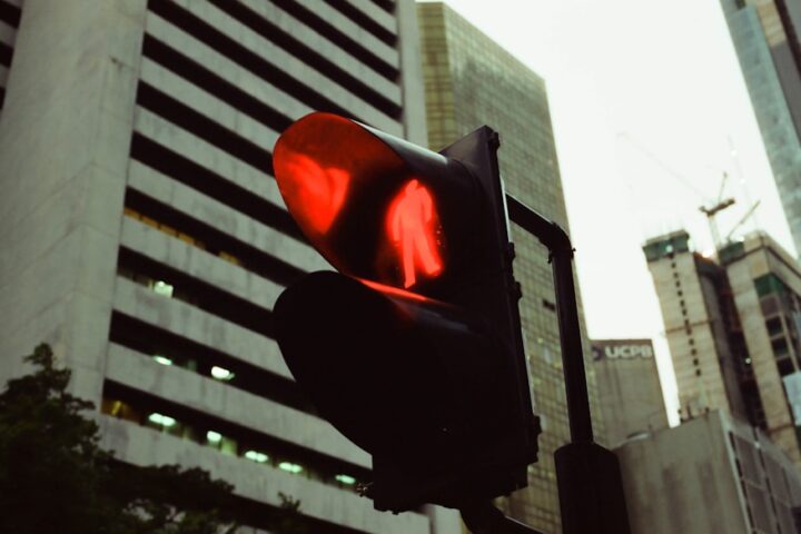 a traffic light in a city with tall buildings in the background