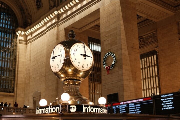 A train station with a large clock in the middle of it