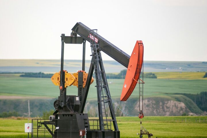 black and orange metal machine on green grass field during daytime