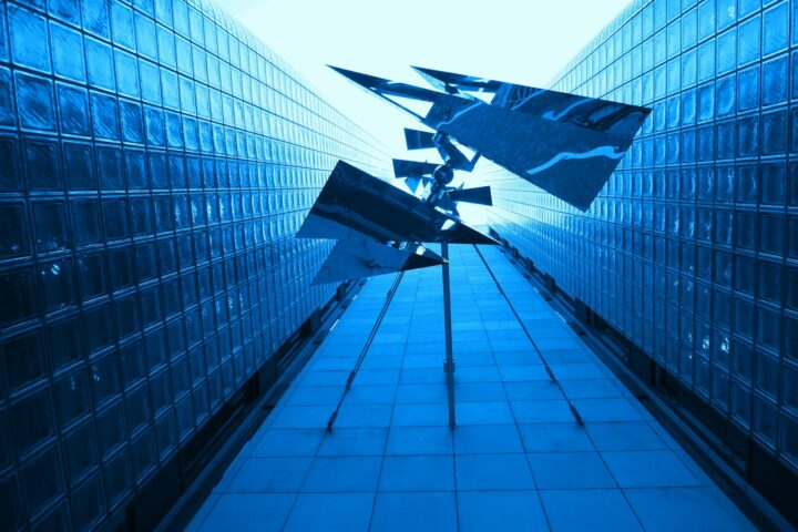 black and white plane flying over the building during daytime