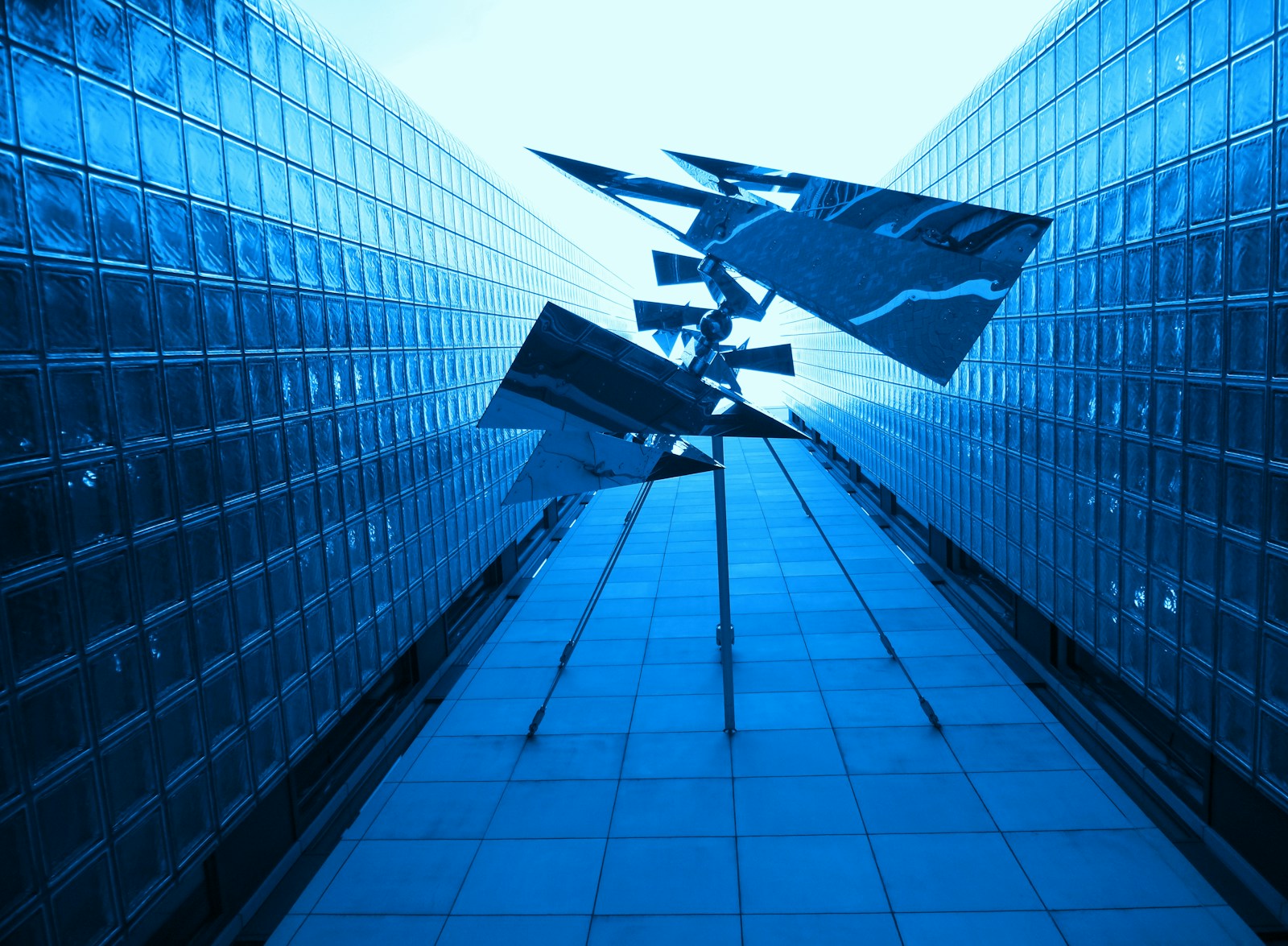 black and white plane flying over the building during daytime
