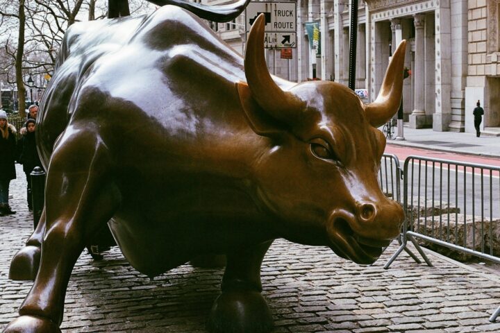 A statue of a bull on a city street