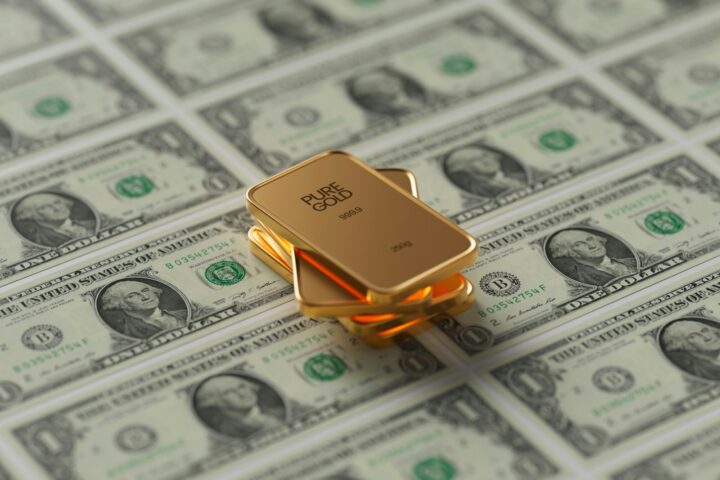 a gold bar sitting on top of a pile of money