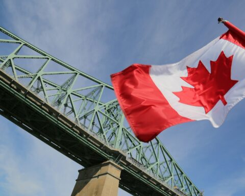 a flag flying in front of a roller coaster