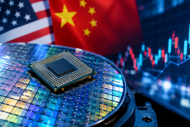 A semiconductor processor resting on a silicon wafer with U.S. and Chinese flags in the background and a glowing stock market chart, representing AI chip demand and global semiconductor competition.